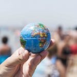young man with a world globe in his hand